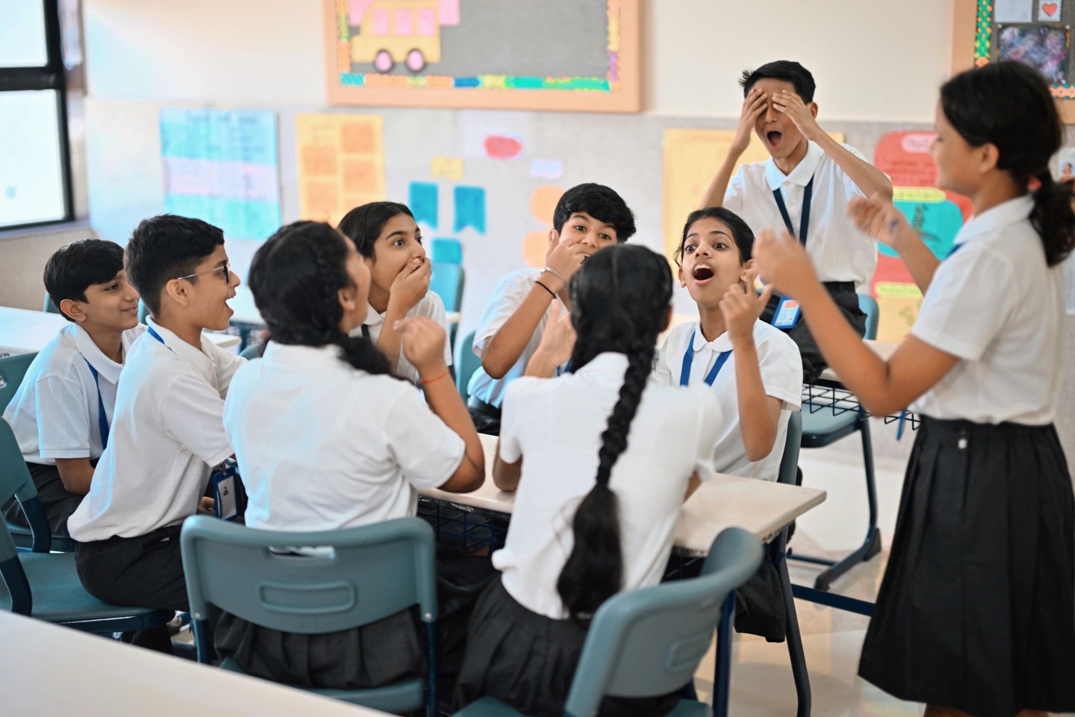 Children gathered around a classroom table during a hands-on learning activity