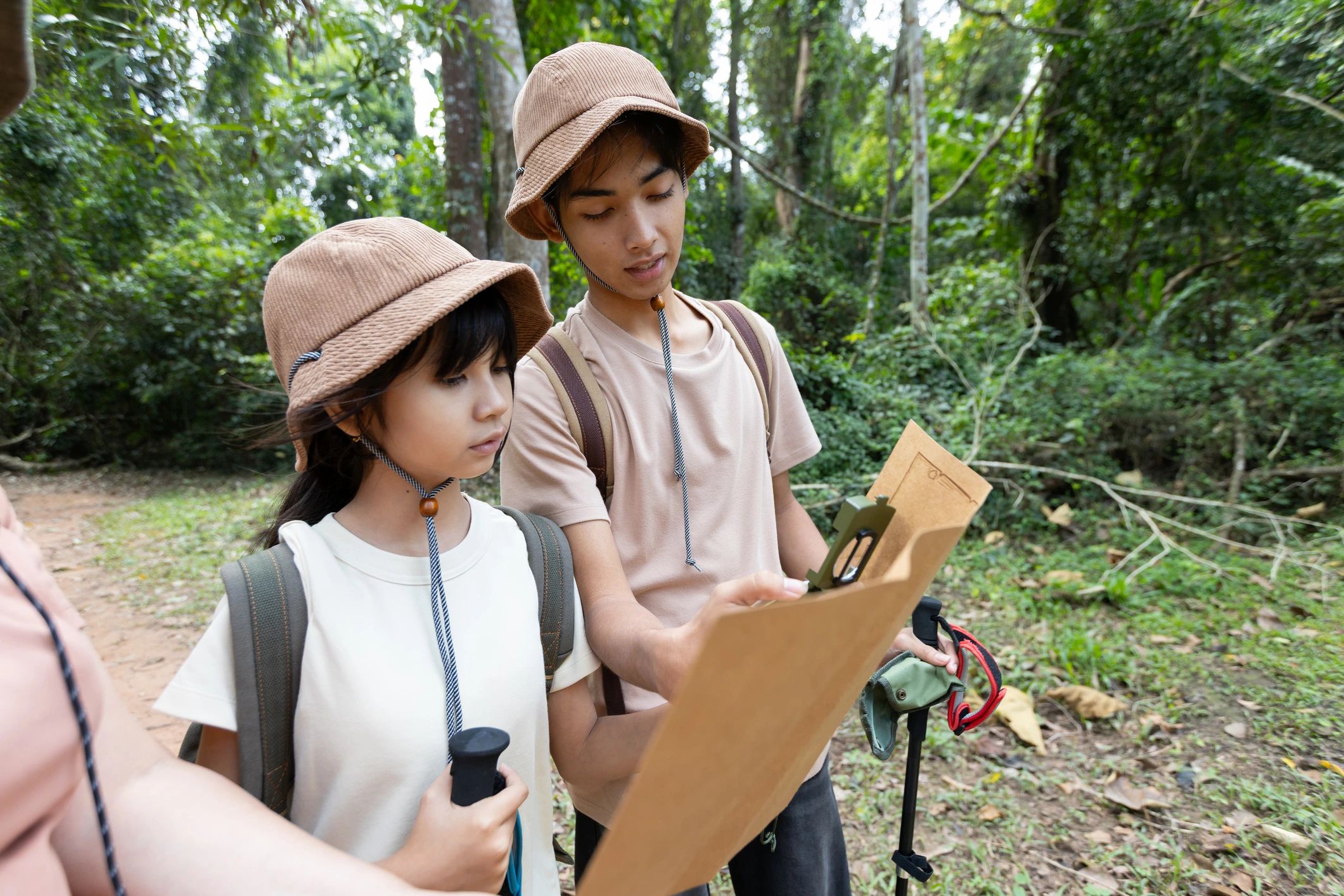 Family exploring outdoors with a map during a nature learning experience